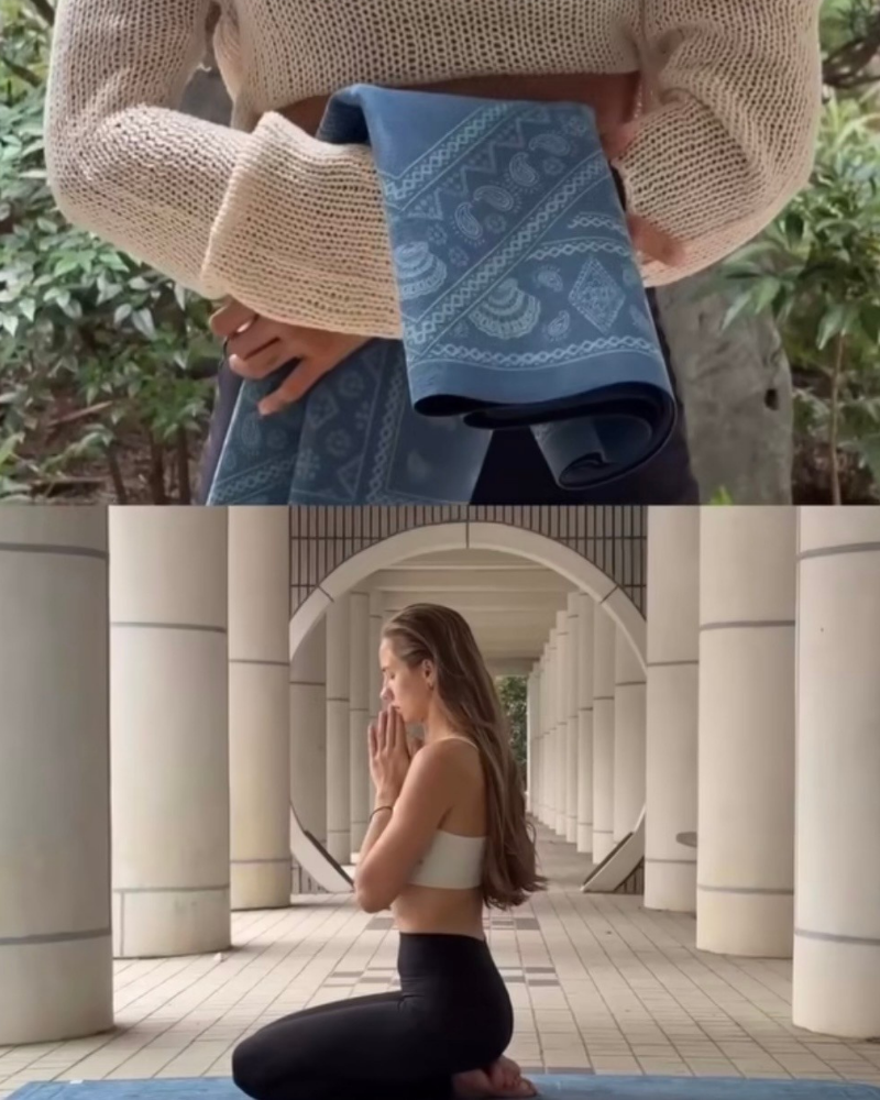 Person holding a oceanic travel yoga mat with a pattern, transitioning to a woman in a white sports bra and black leggings sitting on a yoga mat outdoors.