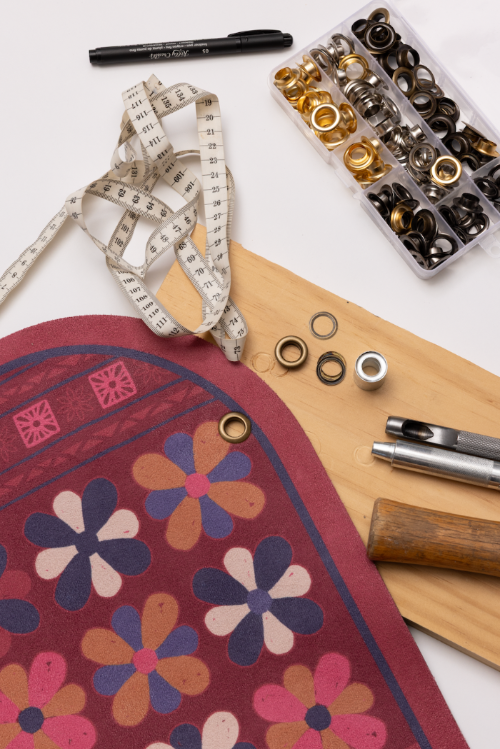 Crafting tools and materials used to add eyelet to hang your premium yoga mat.