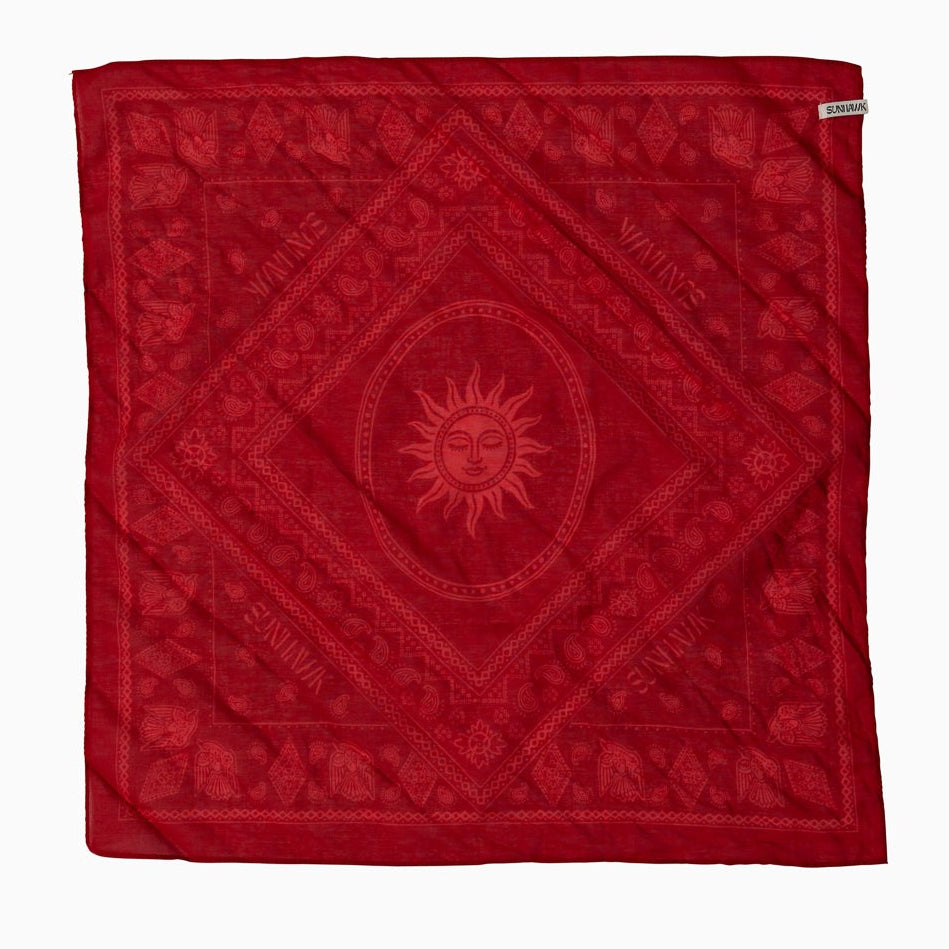 Red bandana with handrawn sun design and text.