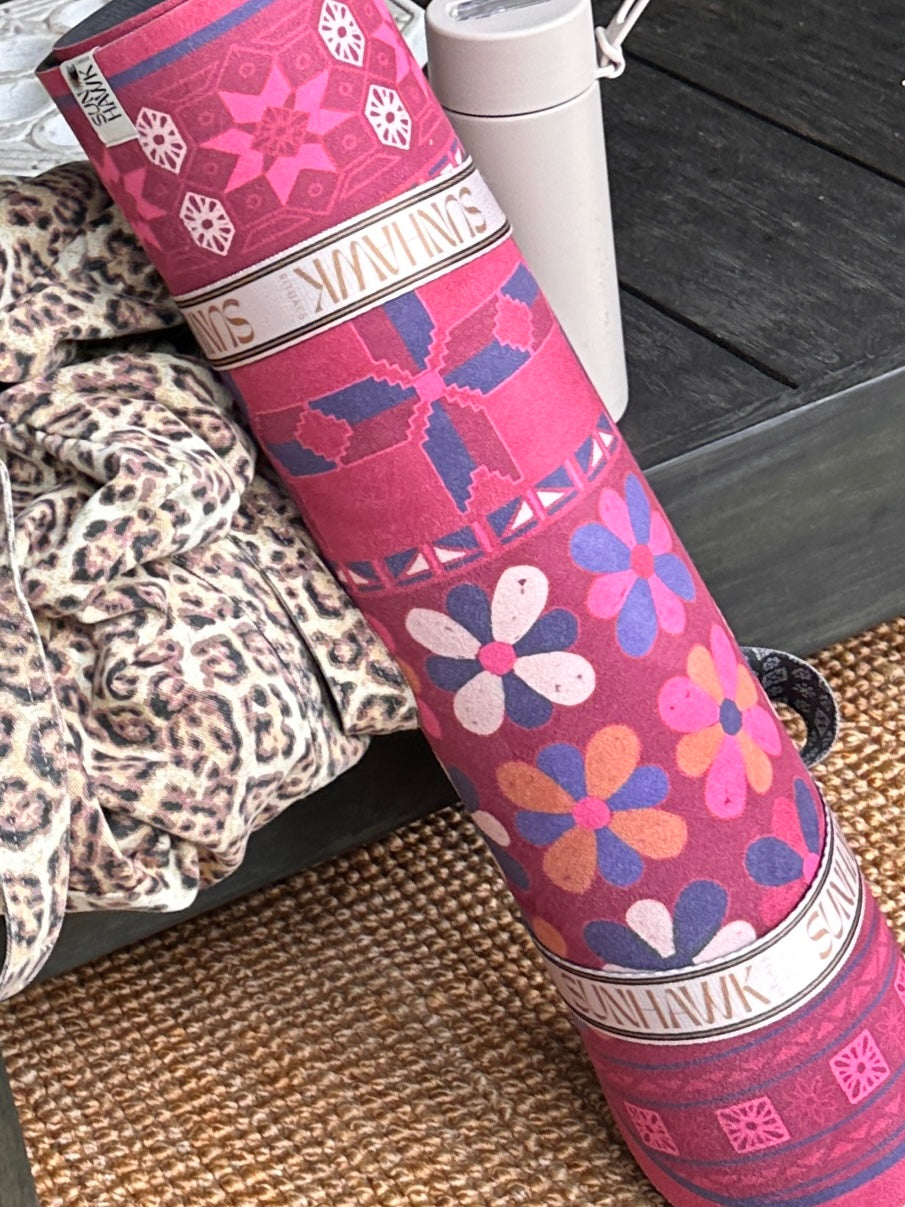 A SunHawk yoga mat rolled ready for a studio class